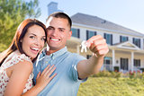 Military Couple with House Keys In Front of New Home