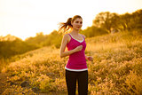 Young Beautiful Woman Running on the Mountain Trail in the Morning