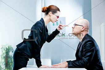 woman reproaching man at work