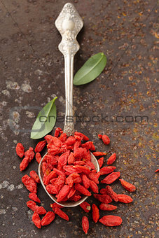 useful red goji berries on a old iron background