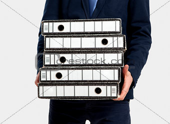 Business man carrying folders