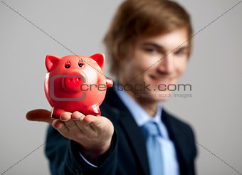 Holding a piggy bank