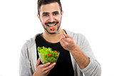 Young man eating a salad