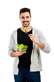 Young man eating a salad