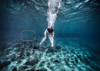 Fashionable model dive into the water