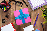 Gift box and office supplies over office table