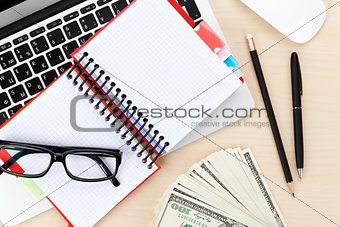 Office table with pc, supplies and money cash