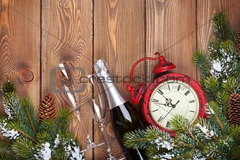 Christmas wooden background with clock, champagne and snow fir t