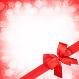 Red ribbon with bow over christmas snow background