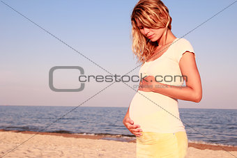 Pregnant woman on seashore