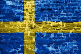 Swedish flag over old wall