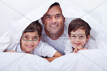 Father and his sons spending some lazy time together