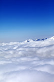 Mountains under clouds and clear blue sky