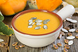 Pumpkin soup with seeds closeup.