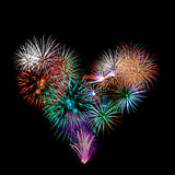 a group of exploding fireworks shaped like a heart.