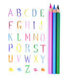 pencils and eraser on the background of the alphabet