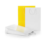 white and yellow gift bags on an isolated white background