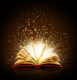 Open magic book with magic lights on a black background