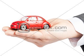 toy car in the hand of business man concept for insurance, buying, renting, fuel or service and repair costs 
