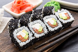 Salmon sushi roll covered with sesame