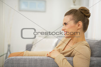 Happy young woman in living room