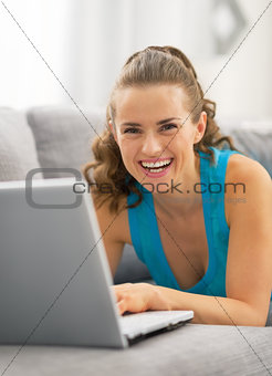 Young woman using laptop in living room