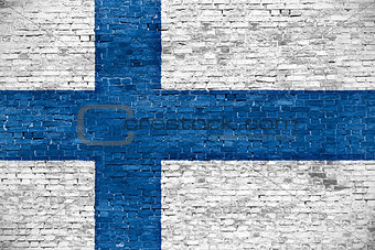 Finnish flag over old wall