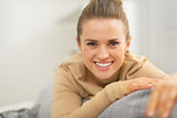 Portrait of happy young woman in living room