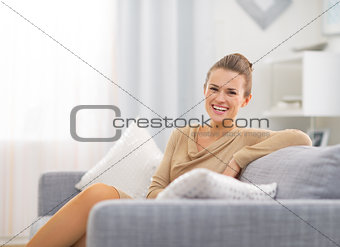 Portrait of smiling young housewife in living room