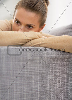Closeup on stressed young housewife in living room