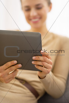 Closeup on young woman using tablet pc