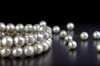 white pearls necklace on black  