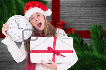Composite image of festive blonde showing a clock and gift
