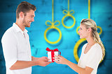 Composite image of young couple with gift