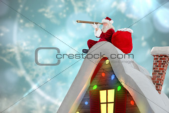 Composite image of santa sitting on roof of cottage