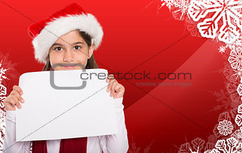 Composite image of festive little girl showing card