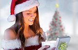 Composite image of pretty santa girl opening gift