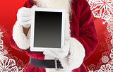 Composite image of santa claus showing tablet pc