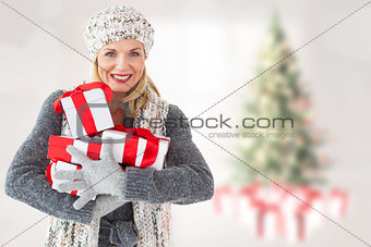 Composite image of happy blonde with gifts