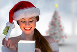 Composite image of sexy girl in santa costume opening a gift