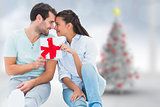 Composite image of young couple holding gift