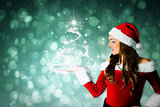 Composite image of pretty girl in santa costume holding hand out