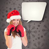 Composite image of festive blonde with boxing gloves
