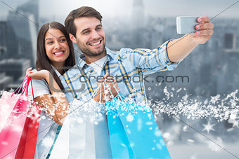 Composite image of happy couple taking a selfie