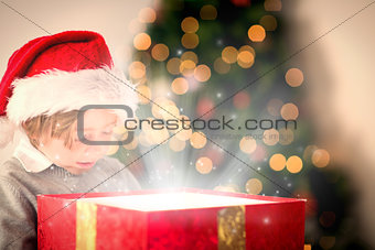 Composite image of child opening his christmas present