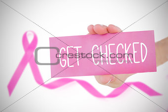 Composite image of young woman holding pink card