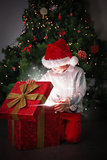 Composite image of child opening his christmas present