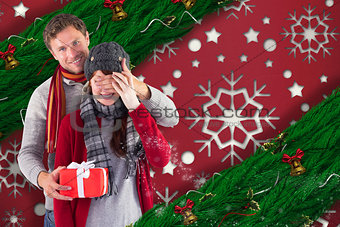 Composite image of man giving woman a present