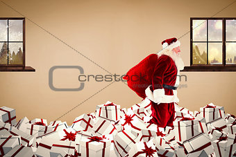 Composite image of santa walking on pile of gifts