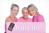 Composite image of embracing women wearing pink tops and ribbons for breast cancer